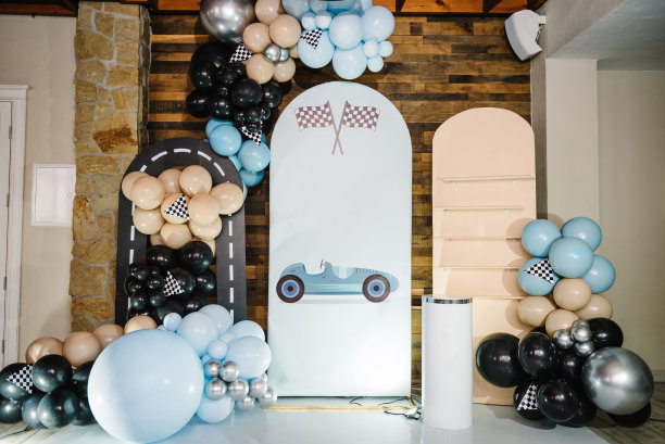 时髦的装饰有旗帜，赛车，轮子，男孩的车。生日装饰用蓝色，棕色，黑色，银色气球为聚会。为庆祝活动做准备。照片墙装饰空间或文字的地方。图片下载