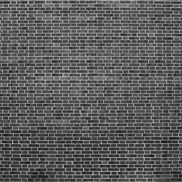 灰度背景与旧现实的黑砖墙。砖墙的最小碎片特写。极简主义的单色背景与墙的灰色砖块在不同的阴影。简单的墙面纹理。图片下载