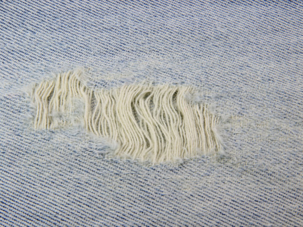 面料由牛仔裤的缝纫缝线构成背景纹理。图片下载