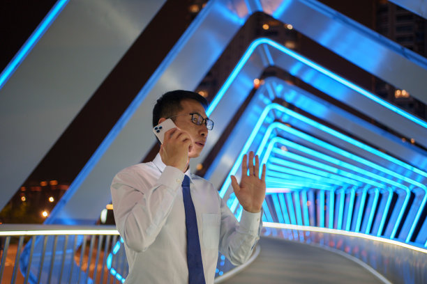 商人在晚上使用智能手机图片下载