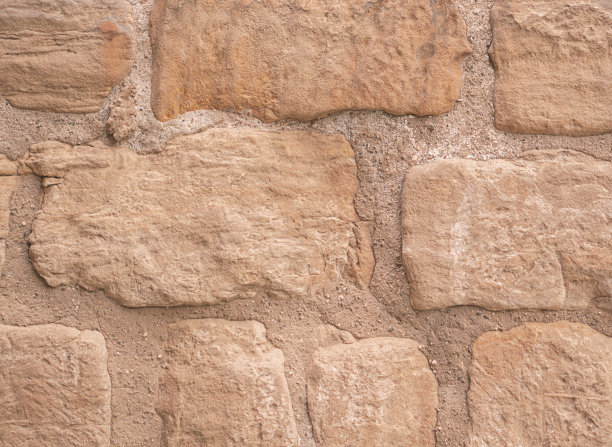 背景是古老的棕色明亮的石墙。图片下载