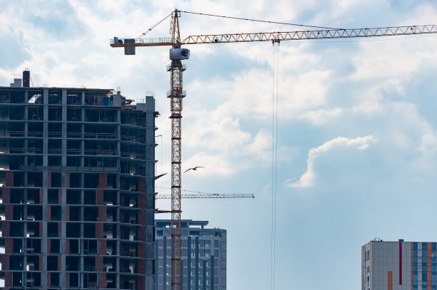 工业建筑起重机在新的现代化建筑上工作。图片下载