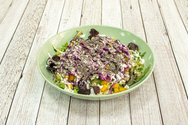 玉米沙拉和酸奶是小麦种子和紫色卷心菜在一个绿色的深盘图片下载