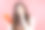 美丽体贴的女人的肖像与智能手机在粉红色的背景图片下载