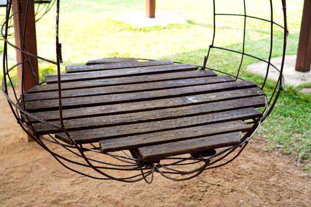 图为公园操场上用回收木板和钢架制成的摇椅。图片下载