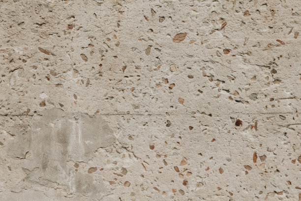 有破损和小岩石的墙的碎片。垃圾贴图特写。老石墙背景。图片下载