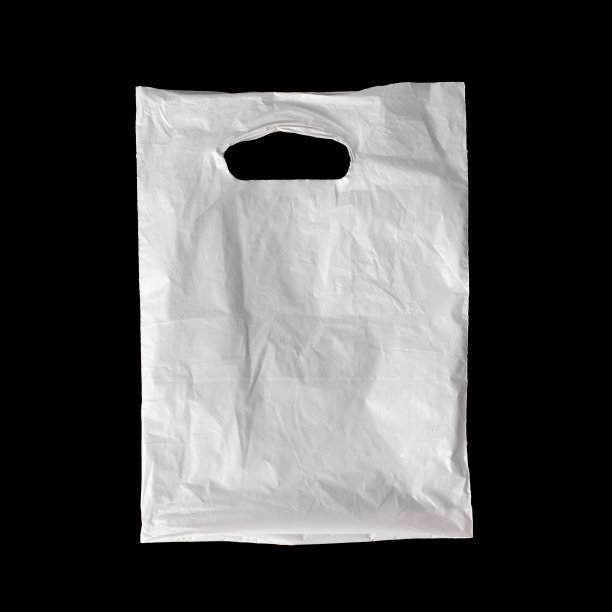 白色塑料袋被隔离在黑色背景上。图片下载