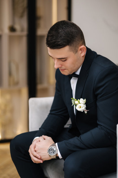 一个人坐在家里的大窗户前。新郎的早晨。结婚的那一天图片下载