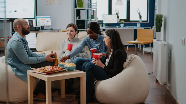 多民族的人们享受啤酒和披萨的乐趣图片下载