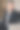 一个穿着优雅深蓝色西装的年轻人坐在家里的椅子上。图片下载