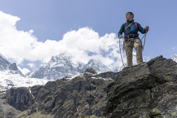 登山者在山顶盘绕绳索图片下载