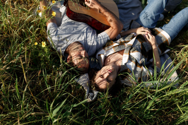 幸福的情侣在公园里野餐，浪漫的约会。弹吉他，在户外玩。俯视图图片下载