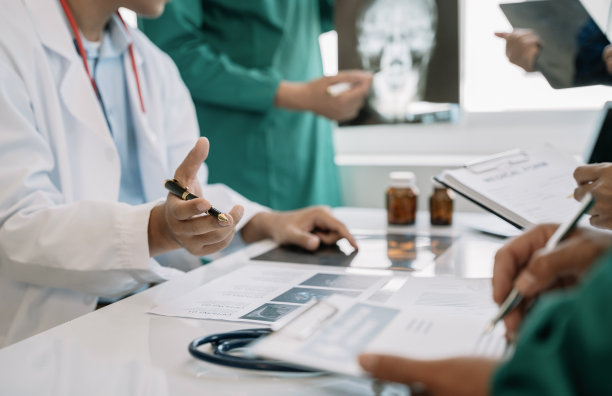 医疗团队致力于数字平板保健医生技术平板电脑，利用电脑对医院的医疗报告结果进行分析。图片下载