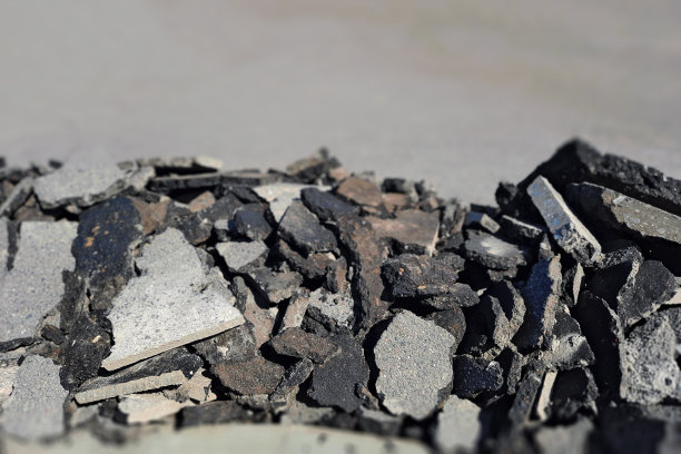 一堆旧沥青。路面修复。柏油路废料图片下载