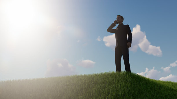 快乐的商人在户外的草山上图片下载