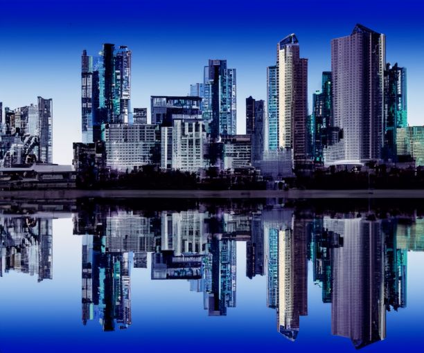 城市的巨大天际线，蓝天映照在水面上图片下载