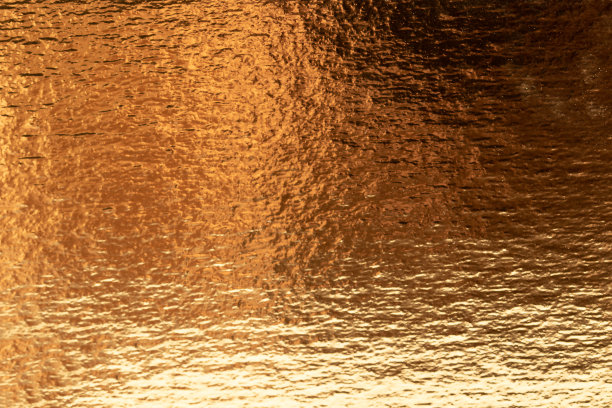 散焦的金箔纹理背景。图片下载