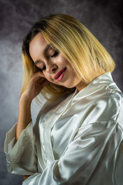 一个美丽的金发女孩的肖像，穿着白色的丝绸长袍，微笑着。图片下载