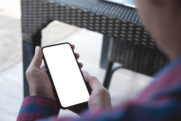 手机空白白屏模型。男子在咖啡店用手机牵手。空白空间模板广告。人们联系企业营销图片下载