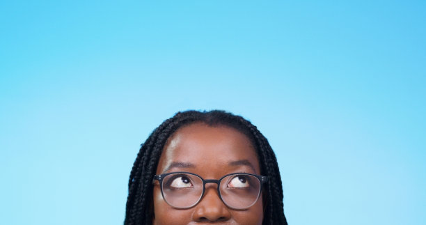 模型，戴着眼镜的女人，在蓝色的工作室背景下做广告。女性和戴眼镜的女孩在特写镜头中有清晰的视野图片下载