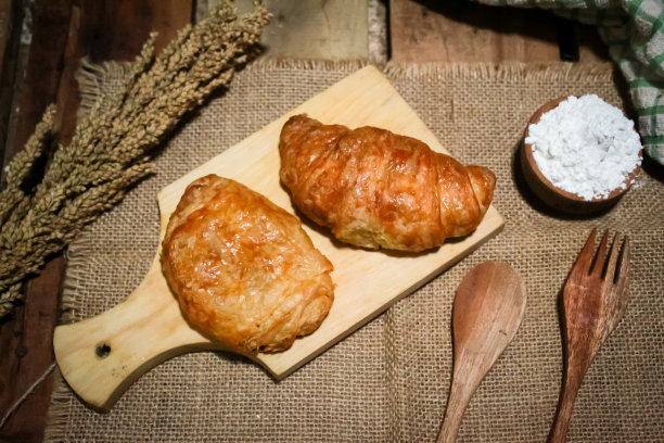 木桌上放着牛角面包图片下载