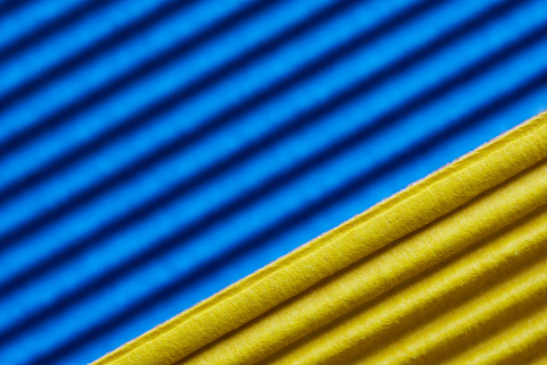 蓝色和黄色的手工瓦楞彩色纸板或纸。创意与纸工艺品的概念。宏。明亮的背景或背景有选择性的重点。图片下载