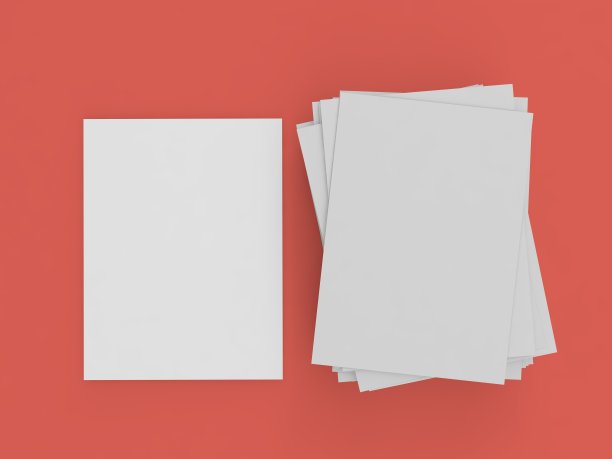 一叠A4纸放在一张红色的桌子上。图片下载