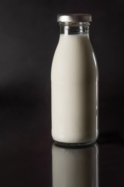 一瓶鲜牛奶，黑色背景特写。图片下载