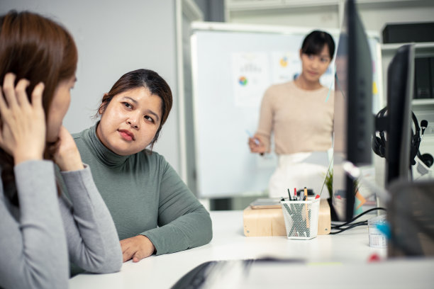 亚洲女人在办公室安慰哭泣的女人。咨询。治疗。图片下载