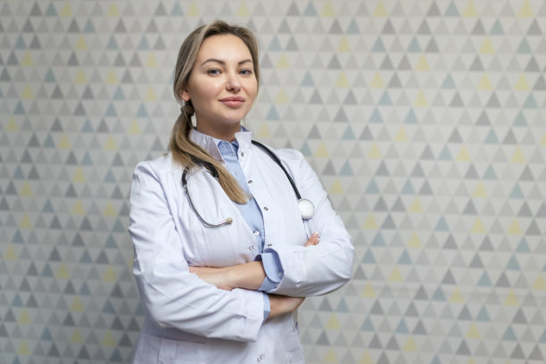 有魅力的家庭女医生的照片咨询病人喜气洋洋友好的微笑，白大褂和听诊器图片下载