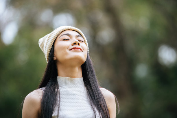 年轻漂亮的女人在森林里美丽的大自然中感到神清气爽图片下载