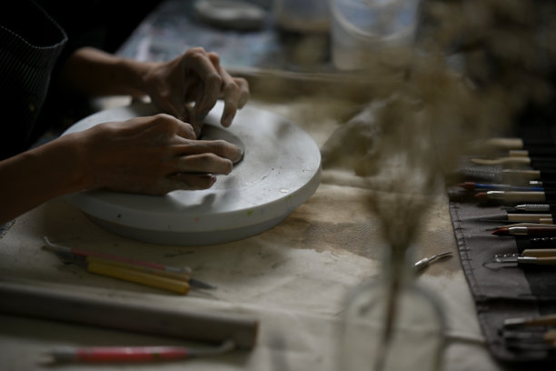 一位专业的男性艺术家用粘土手工制作装饰品的后视图图片下载