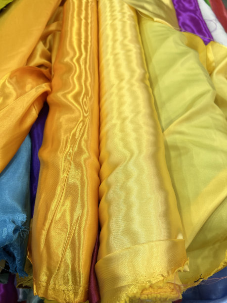 彩色材料织物卷-纹理样品。色彩鲜艳的织物卷图片下载