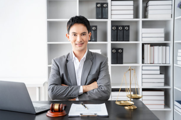 律师的办公室。拿着天平的正义木槌和在笔记本电脑上工作的律师。法律法律，忠告和正义观念。图片下载