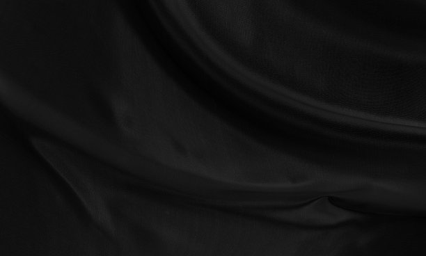 黑灰色缎面深色面料质感豪华光泽，是抽象的丝绸布料背景与图案柔和的波浪模糊美丽。图片下载