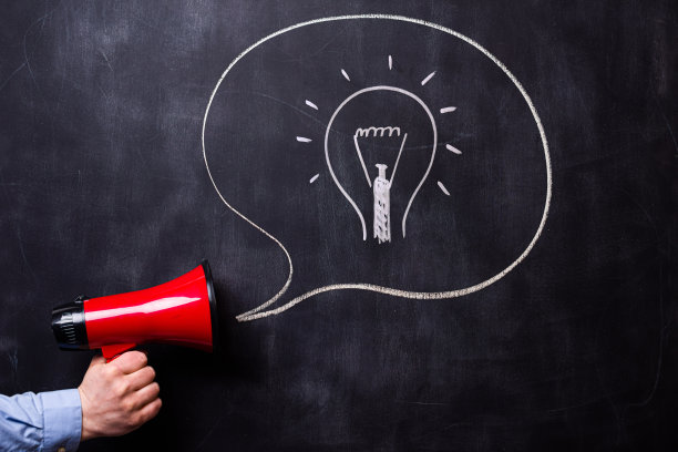 拿着红色扩音器站在黑板前的人。有一个手绘的消息框。图片下载