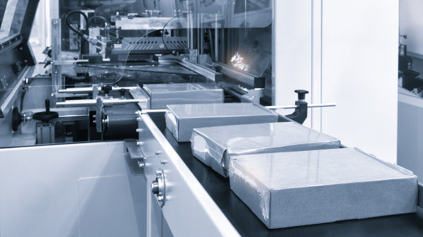 适用于产品、食品塑料包装的光效全自动工业机械。自动包装线用塑料薄膜呈现浅蓝色场景。产品包装理念图片下载