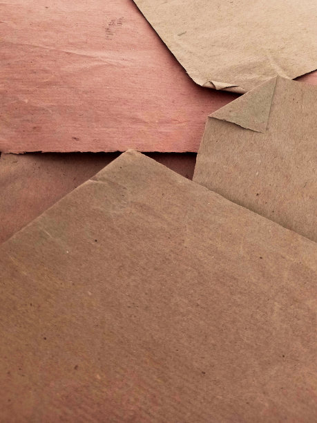 一堆不同大小和颜色的再生纸背景。几张包装纸。纸板和工艺品的概念。图片下载