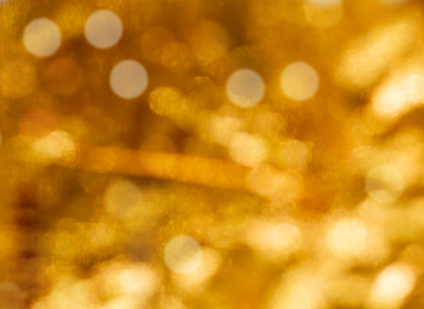 抽象的金色火花。闪闪发光的抽象优雅的金色背景。图片下载