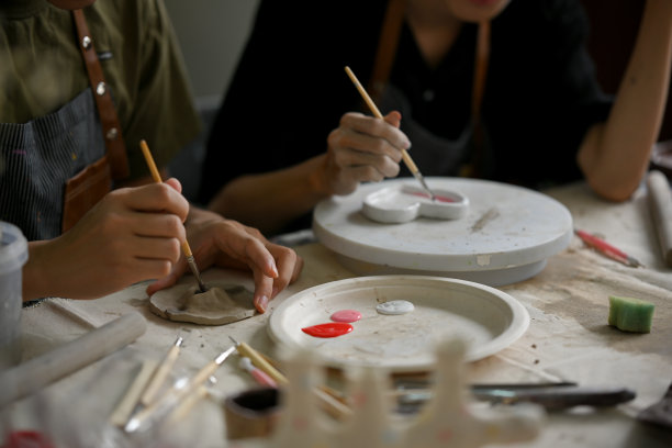 一个男人喜欢用丙烯酸颜料画陶瓷板的特写图片图片下载