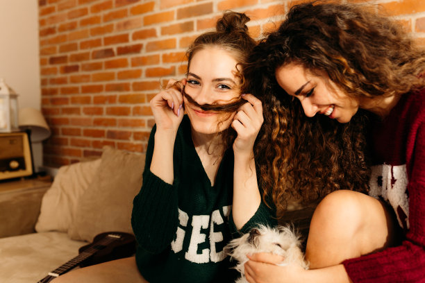 两个女孩用胡子开玩笑，玩得很开心图片下载