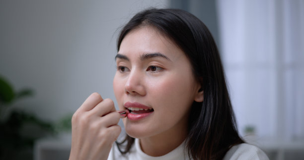 美丽的年轻亚洲女性博主向我们展示了如何化妆和使用化妆品图片下载