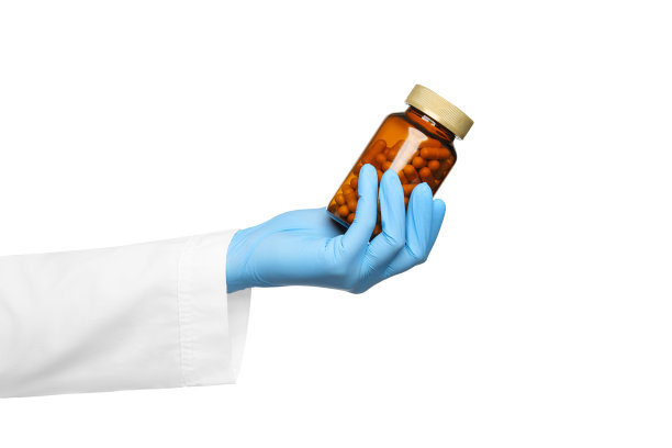 白底药:医生或护士手中的一罐白底药换上医疗服和医用手套。图片下载