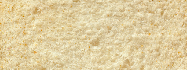 切片新鲜出炉的白面包的结构，面包店背景特写。图片下载