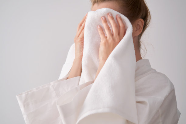 女孩用毛巾擦脸。图片下载