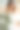 年轻的女士穿着带羽毛的结婚礼服坐在床上，手里拿着花束。新娘掀开布料向下看。图片下载