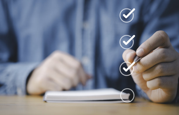 业务人员用笔在质量文件控制清单和业务批准项目概念的复选框中勾选正确的符号标记。图片下载