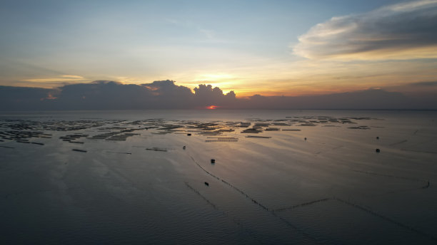 风景与海上日落，美丽的日落在海上，鸟瞰日落天空，大自然美丽的光日落或日出在海上，多彩的戏剧性雄伟的景色天空与惊人的云彩和波浪在日落天空暗光云的背景图片下载