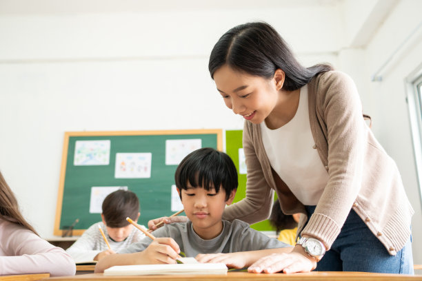 一个亚裔日本男孩在书桌前写字图片下载