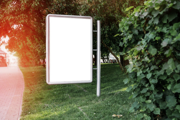 空的白色广告牌安装在城市公园的绿草地上图片下载